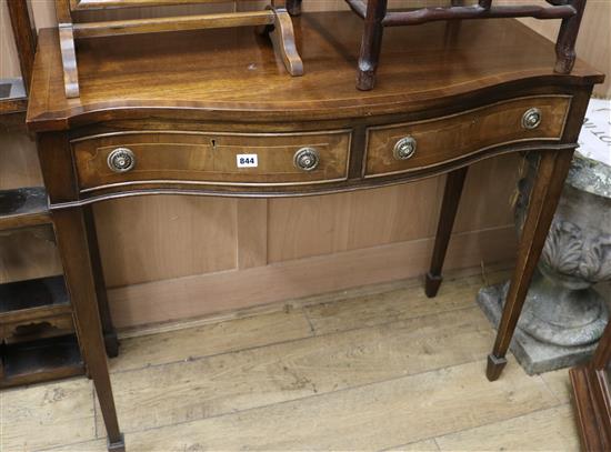 A George III style mahogany and line inlaid serpentine fronted two drawer side table W.98cm